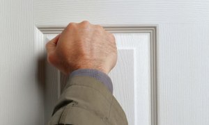 A-hand-knocking-on-a-door-007